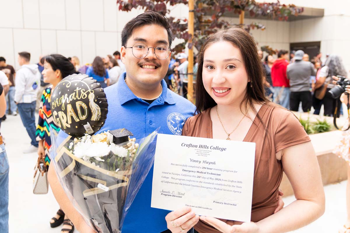 Grad holding certificate posing with family