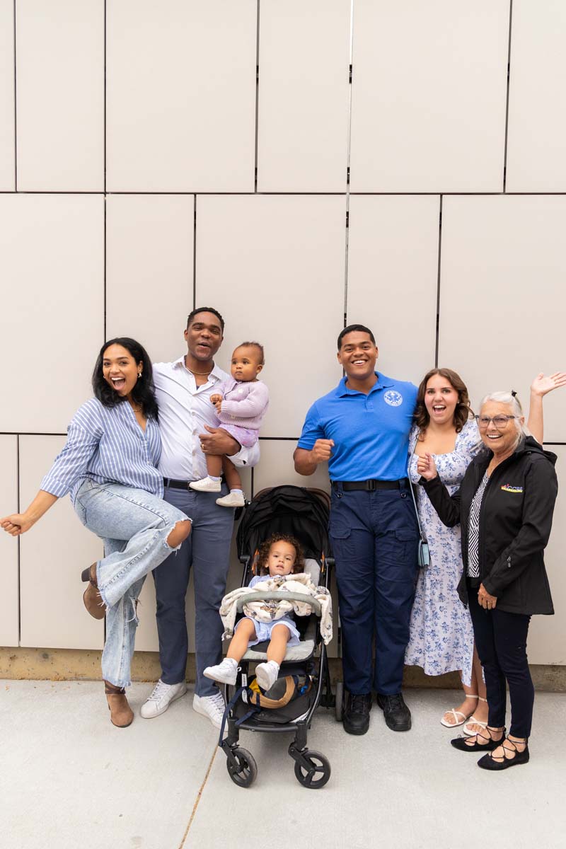 Grad posing with family