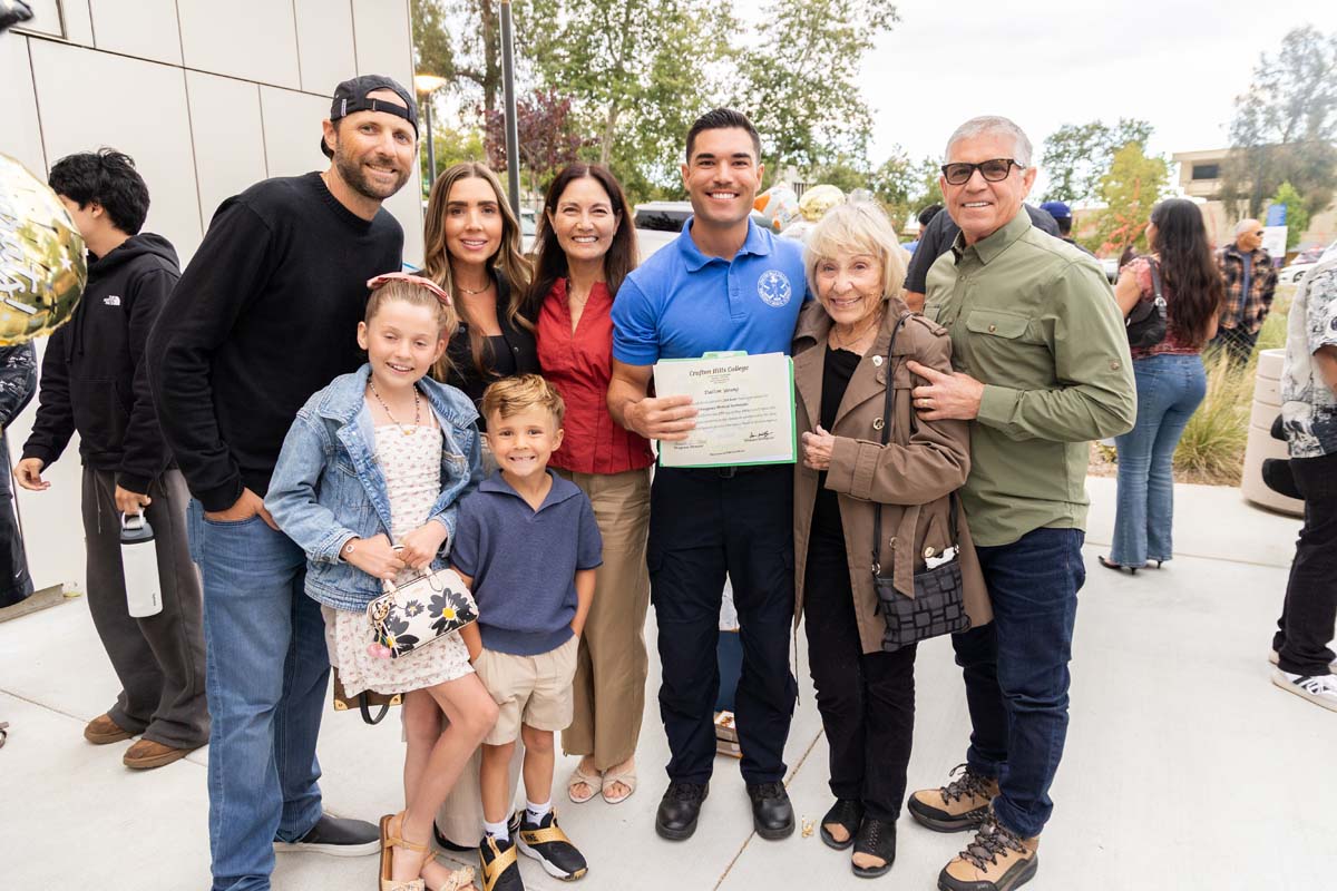 Grad posing with family