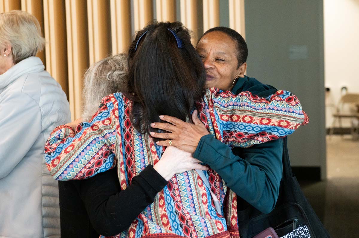 Three people hugging