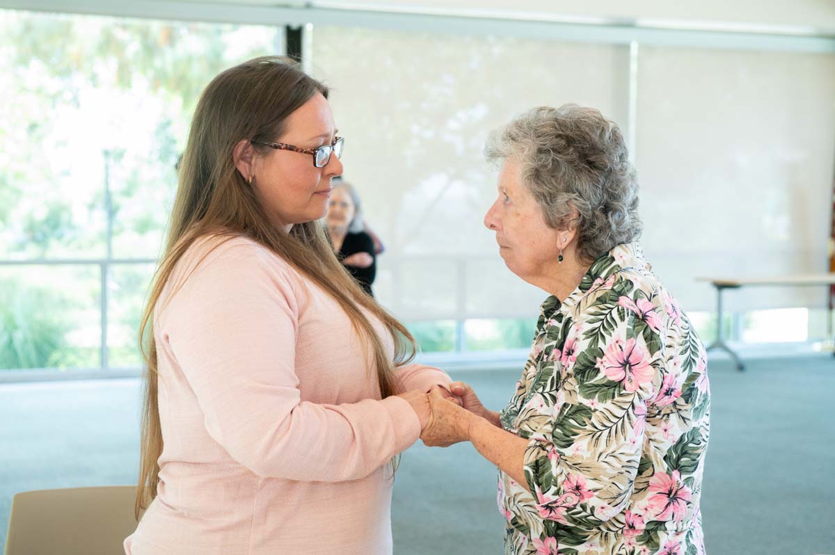 Two people holding hands and talking