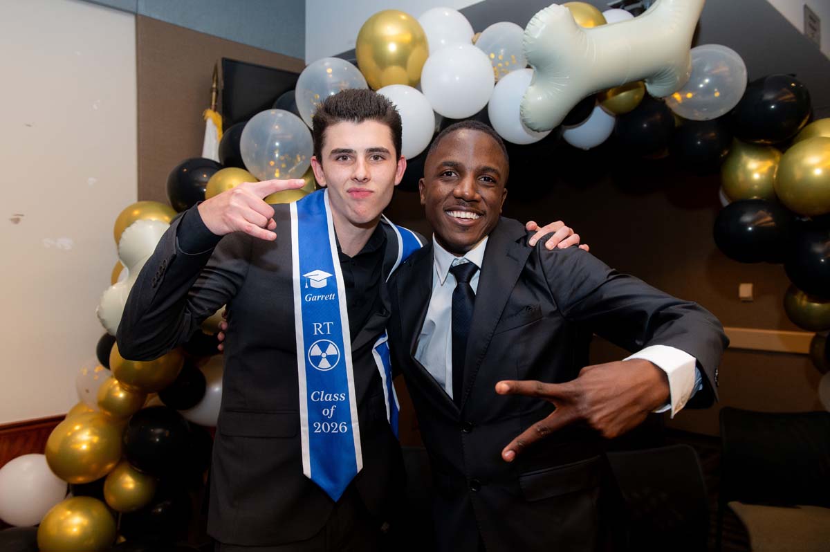 Two grads posing
