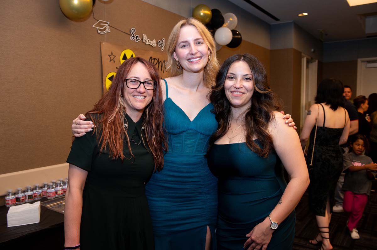 Three grads posing
