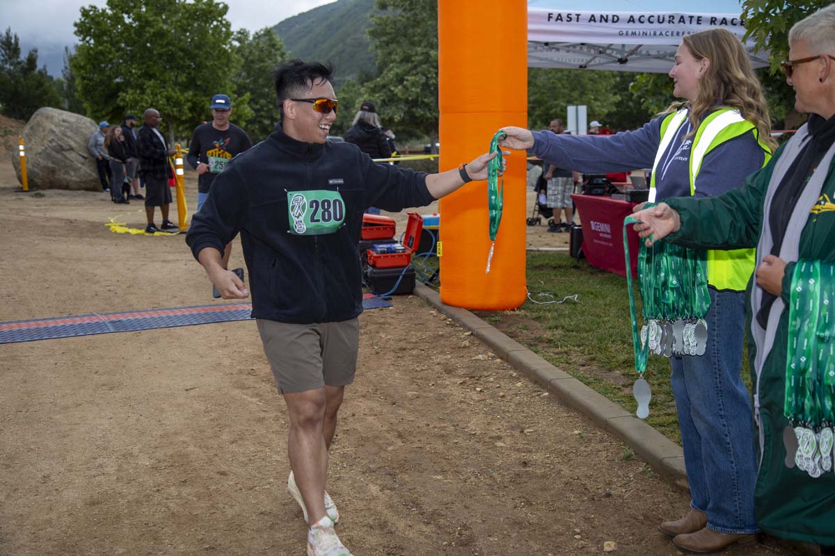 Racer grabbing for medal