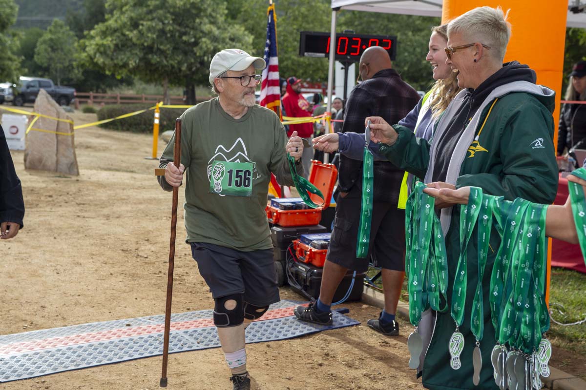 Racer reaching for medal