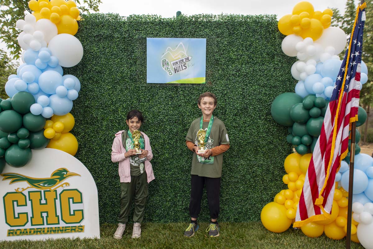 Two racers with trophies