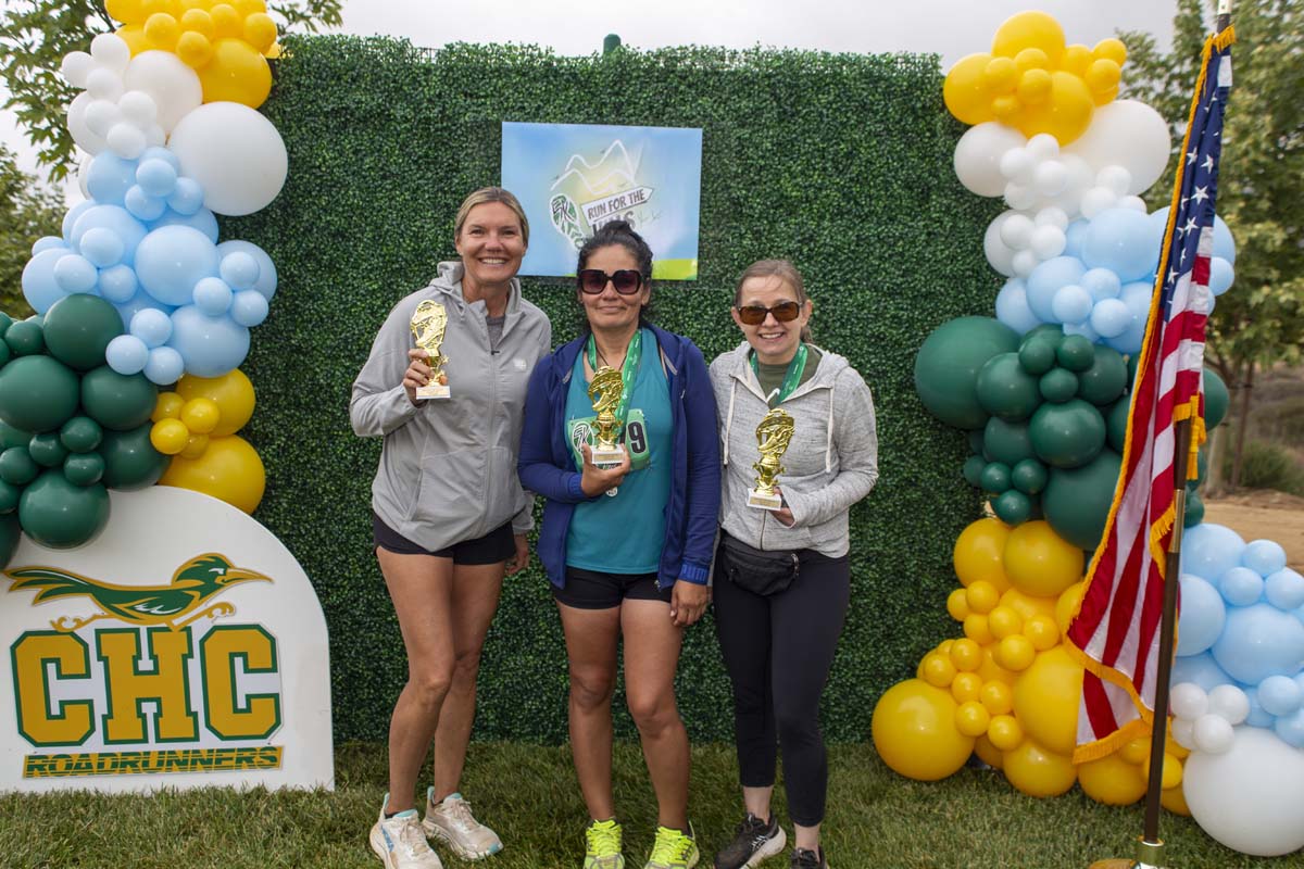Three racers with trophies