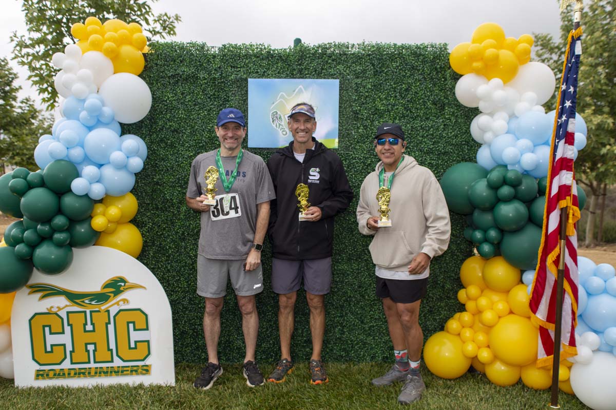 Three racers with trophies