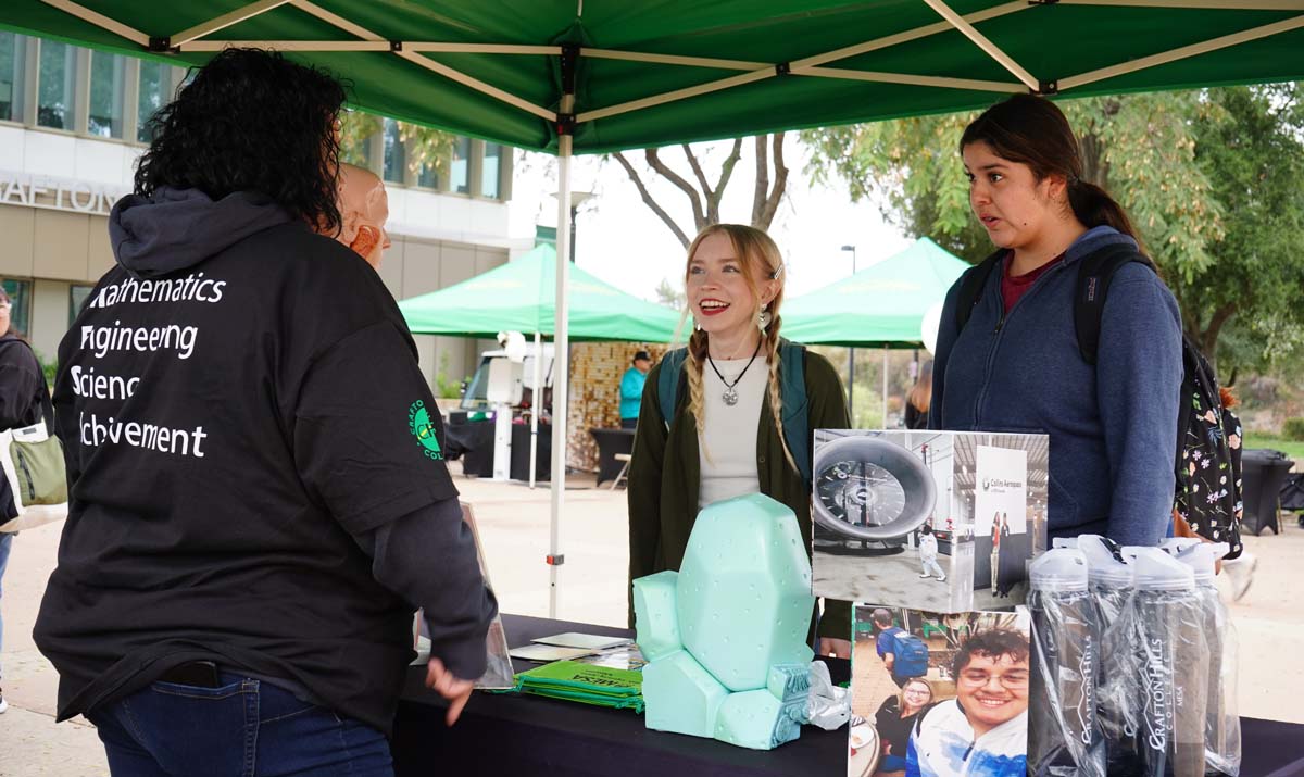 Students talking at a booth