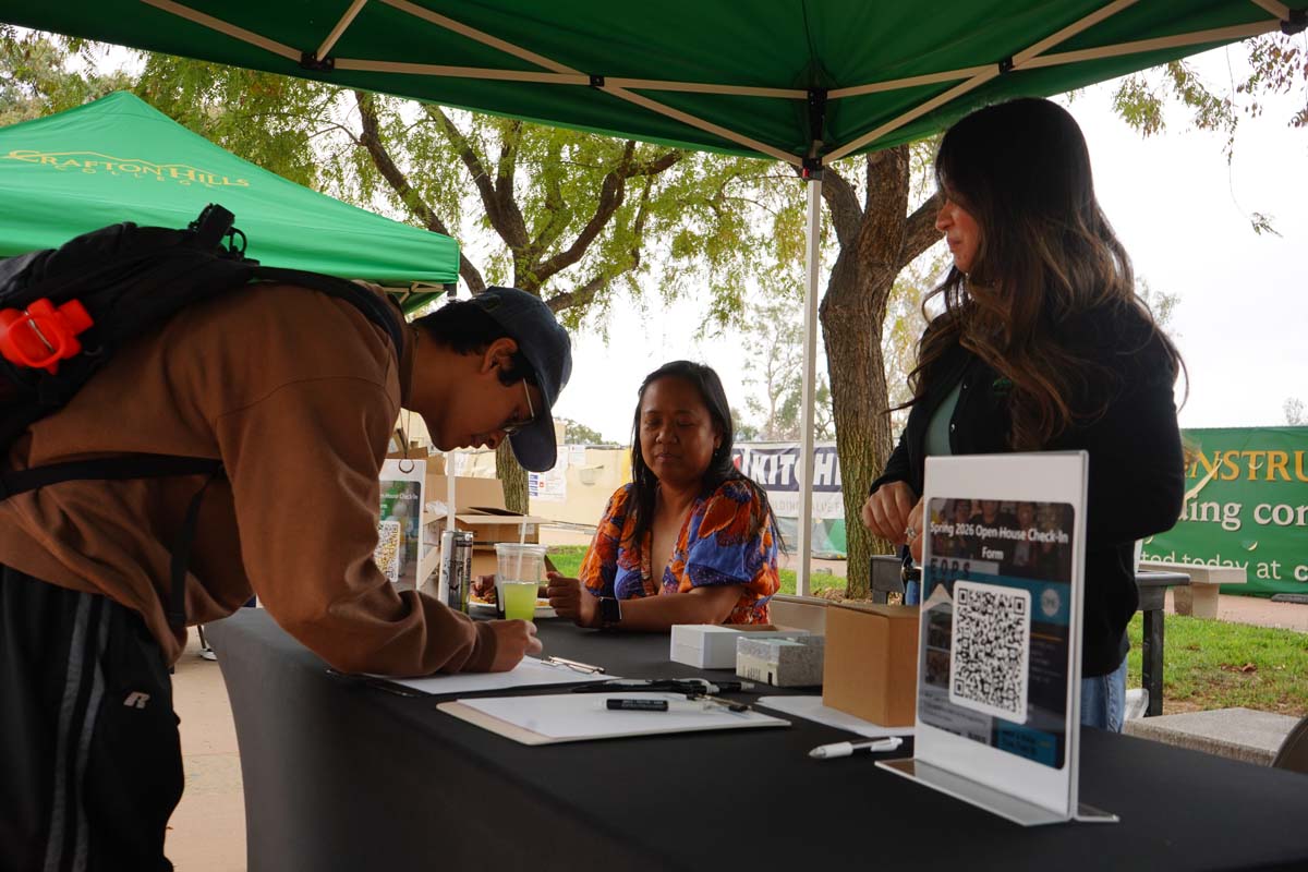 Student signing up at a booth