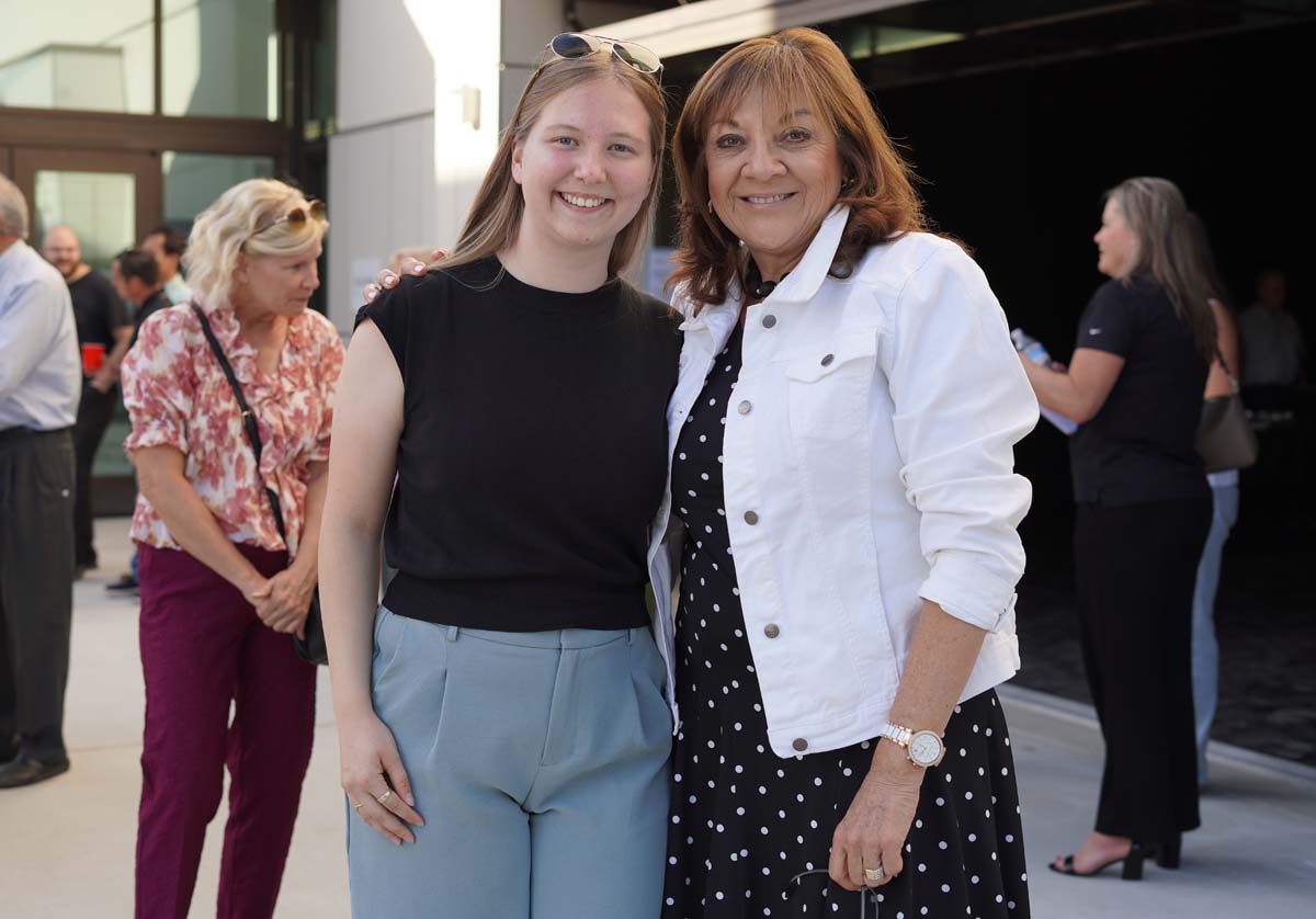 Two people posing at event