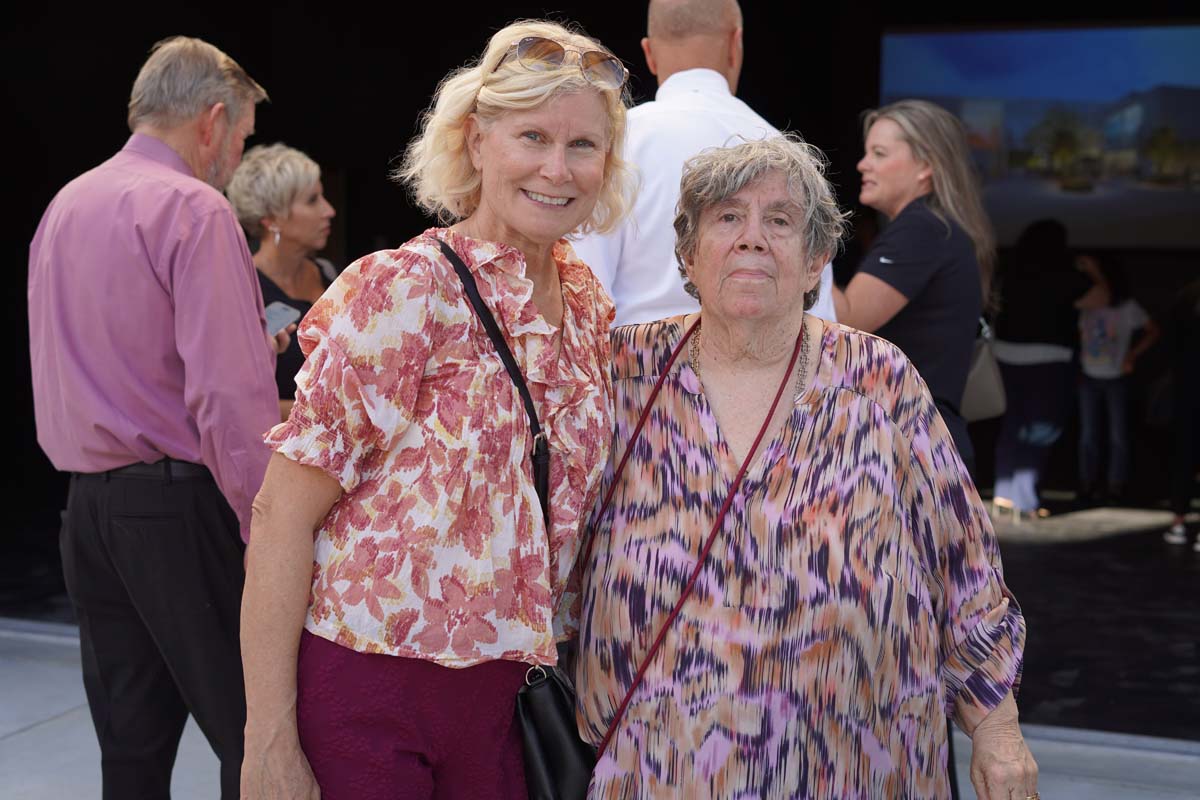 Two people posing at event