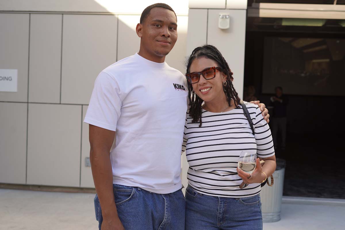 Two people posing at event