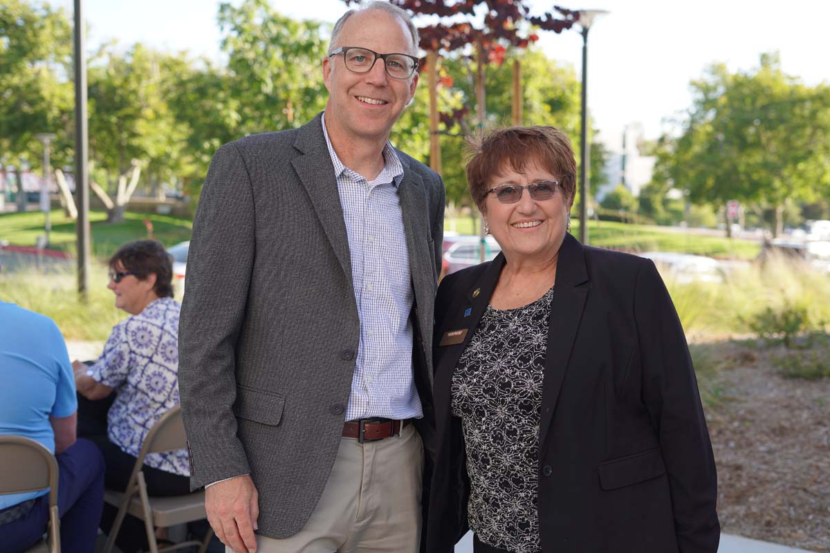 Two people posing at event