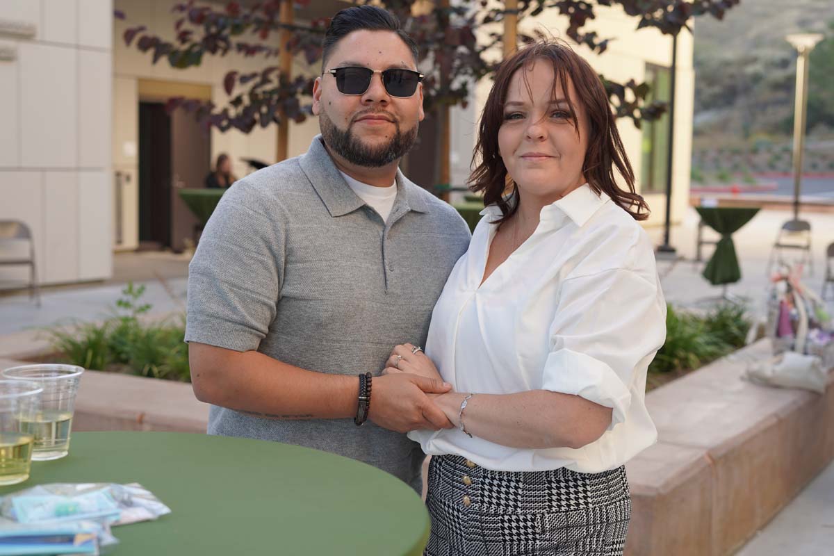 Two people posing at event