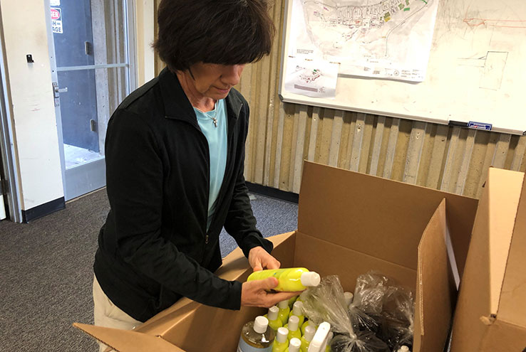 Janine Ledoux examines a box of donations
