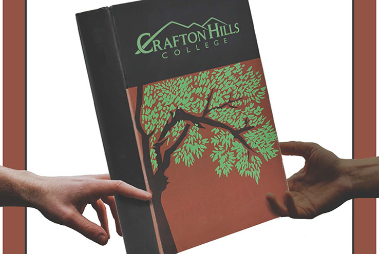 Hands holding a book with the Crafton Hills College logo on it.