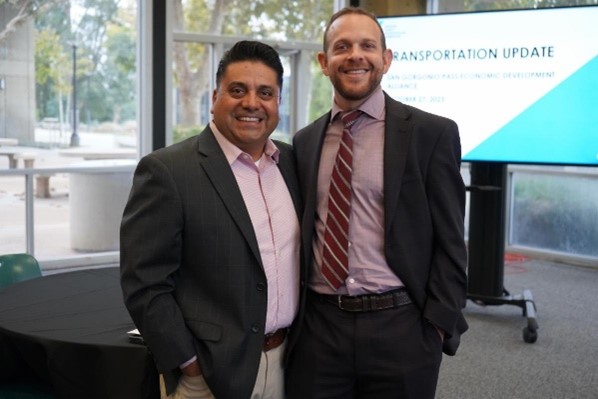 Two men in front of presentation screen