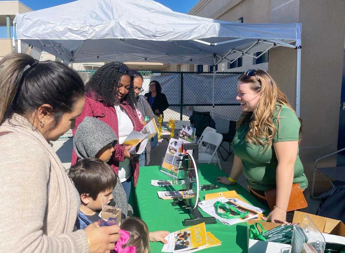 CHC’s Student Services Technician Jamie Sierra speaks with RUSD families.