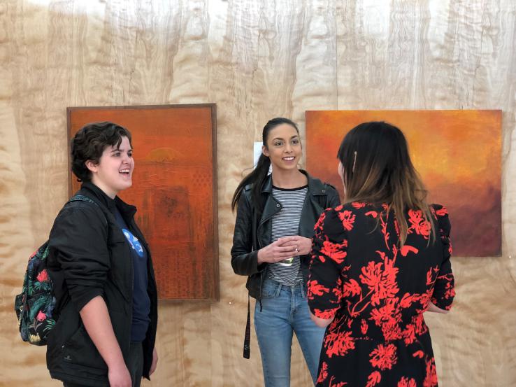 Students talking to curator in gallery