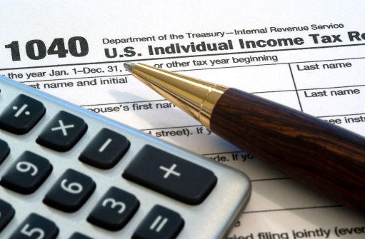 Pen, calculator and tax form