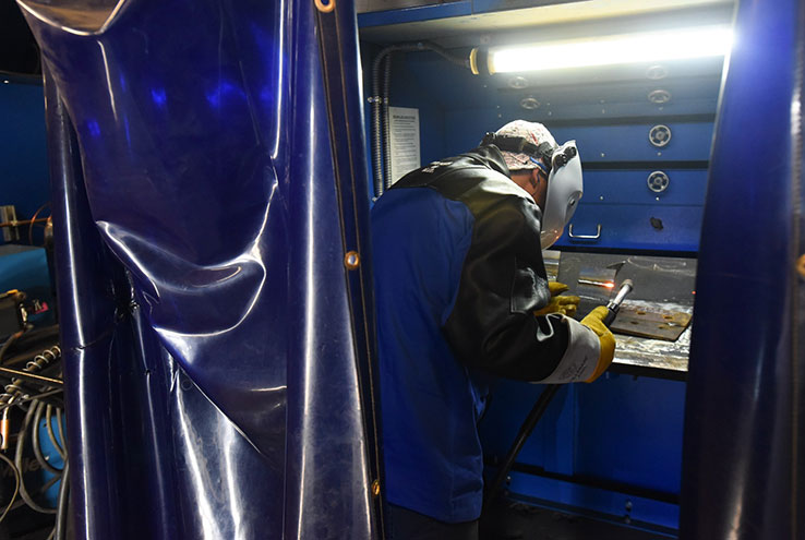 Man working with specialized equipment in protective gear