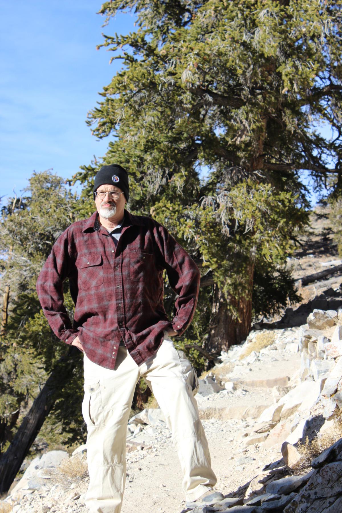 Richard Hughes standing on rock formation